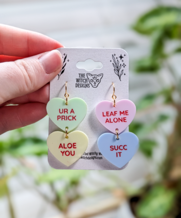 mean and punny plant themed candy heart earrings