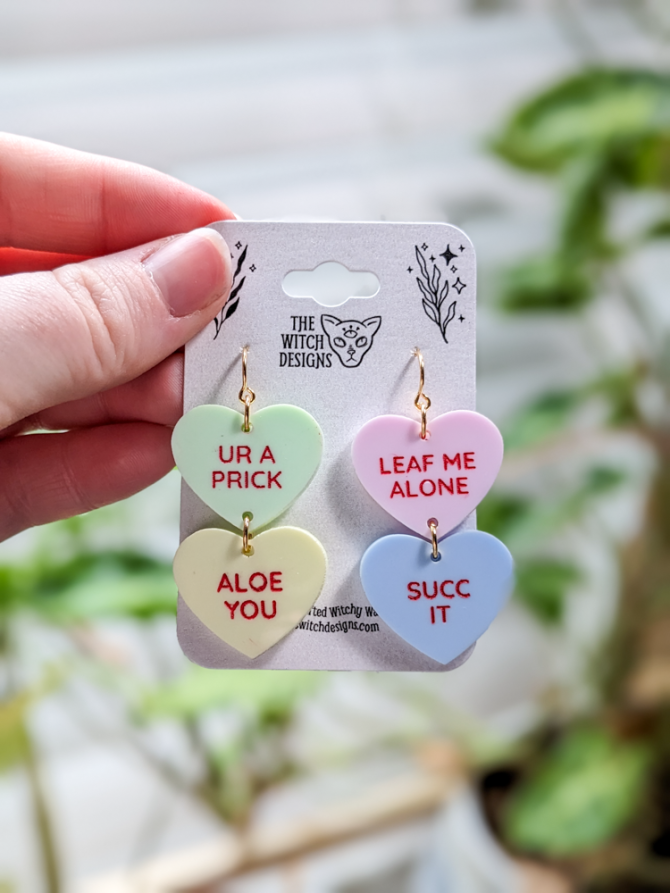 mean and punny plant themed candy heart earrings
